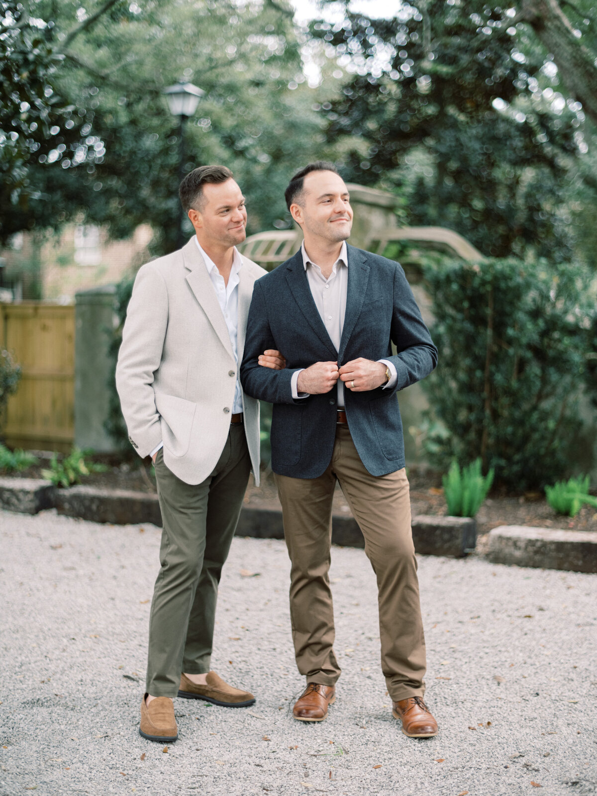 A couple confidently poses in a serene outdoor environment. Their stylish outfits and relaxed demeanor highlight a moment of togetherness and happiness amidst beautiful surroundings.