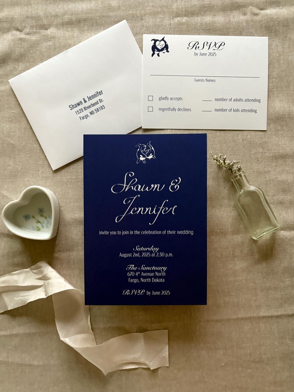 blue and white wedding invitation flat lay with rsvp card and envelope