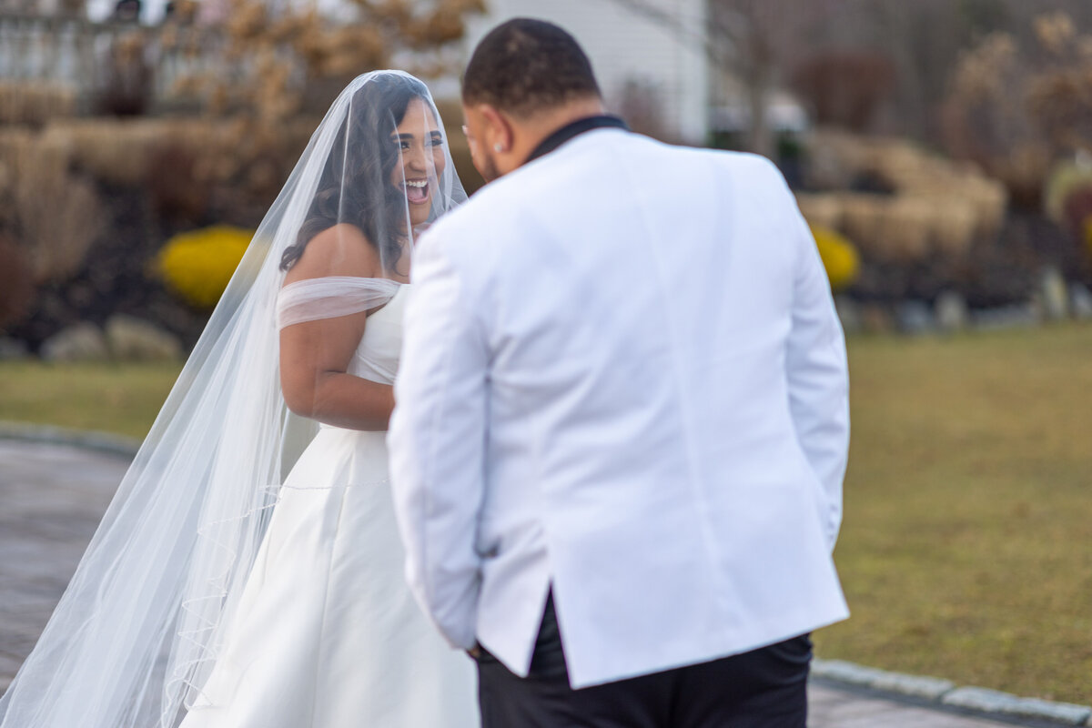 Groom looking at bride during their first look