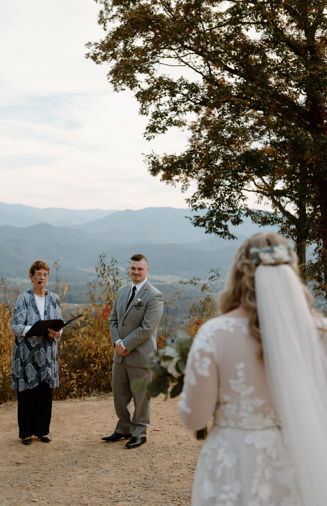 Groom's reaction to bride walking down the aisle at a mountain overlook elopement in Tennessee.