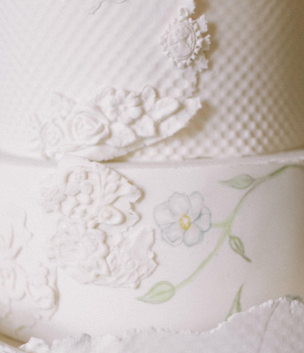 up close photo of a textured white wedding cake taken by Mansfield Wedding Photographer, Annie Trammel