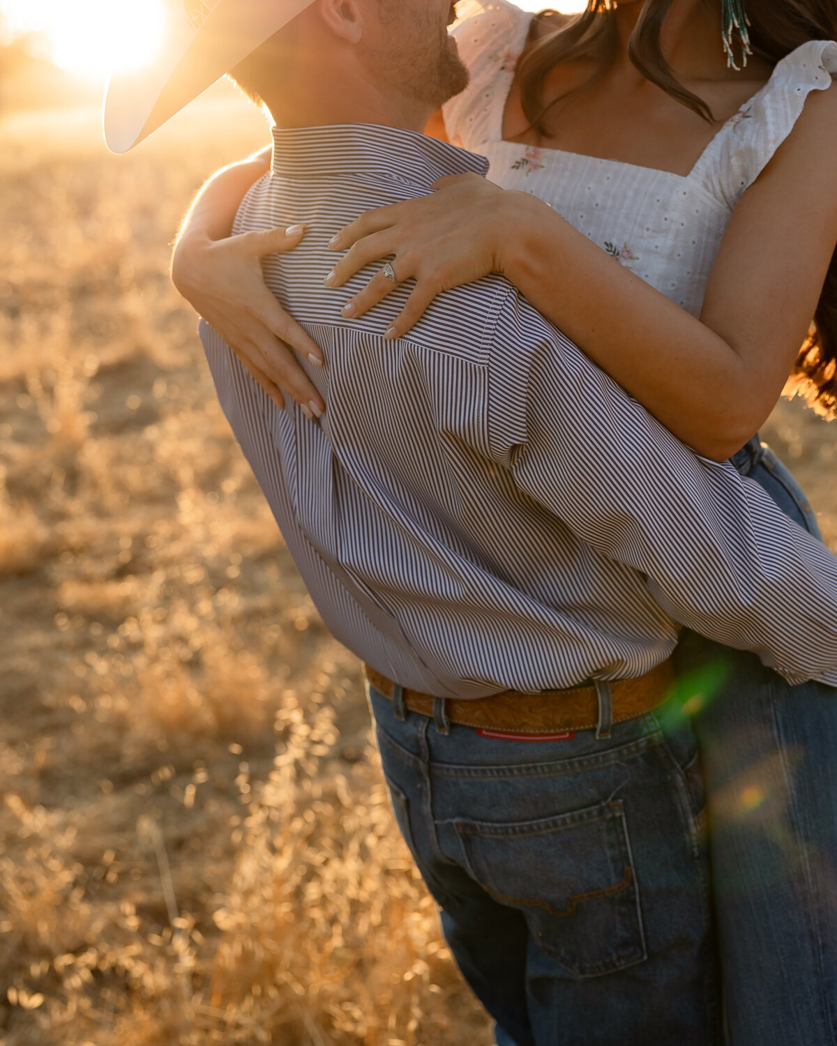 candid couples engagement photos in open field during golden hours in San Luis Obispo