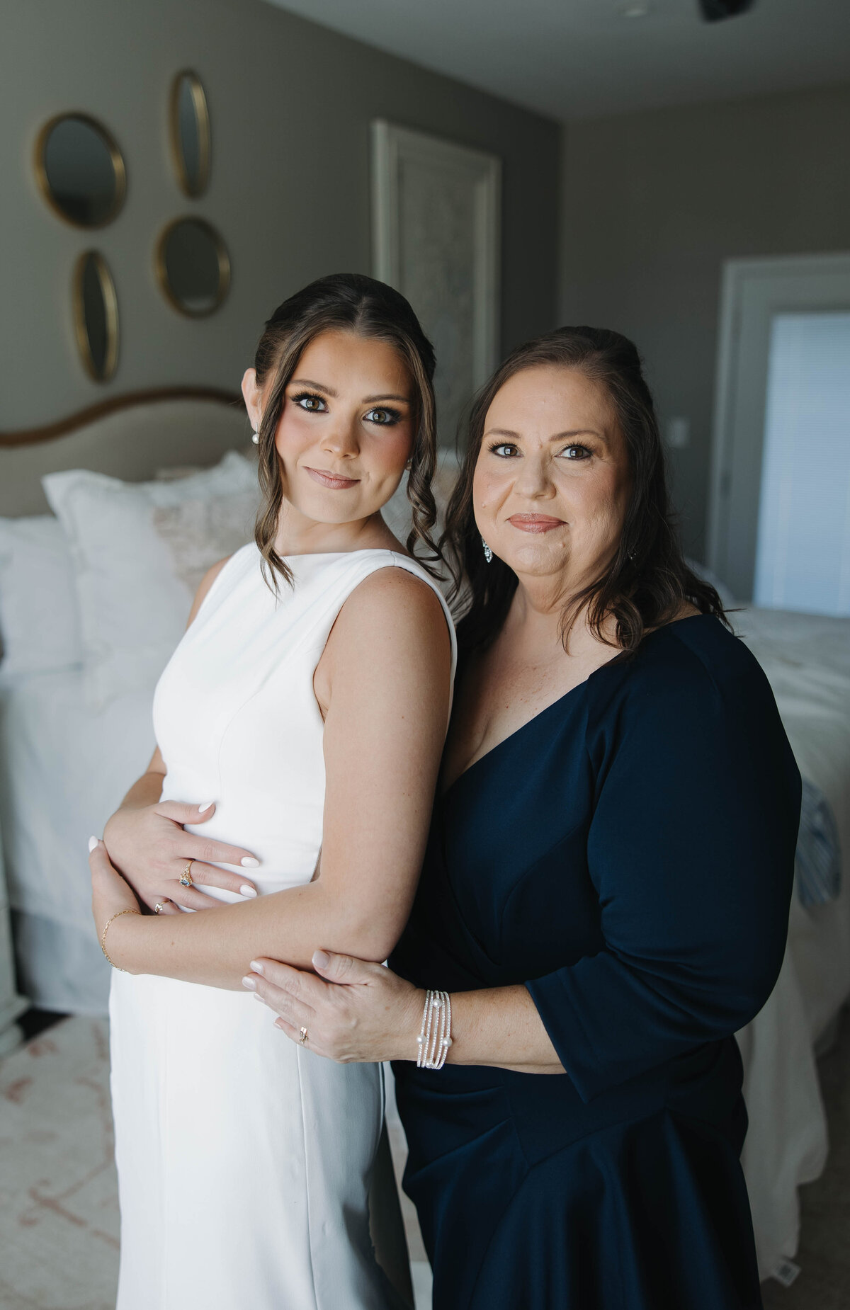 brides mother helping bride get ready