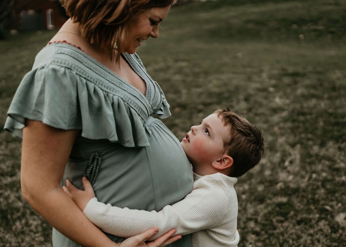 Captured a tender moment between a mother and her son in a beautiful field. Contact our Pittsburgh maternity photographer for unforgettable memories.