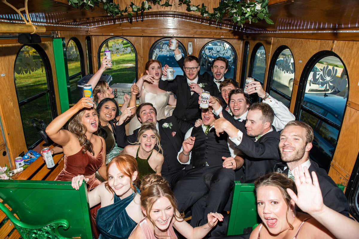 A group of people are posing for a picture while sitting on a bus