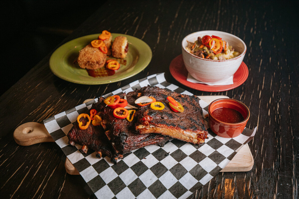A plate of spare ribs sits on a dark table at the Yeti in Fort Collins, Colorado.