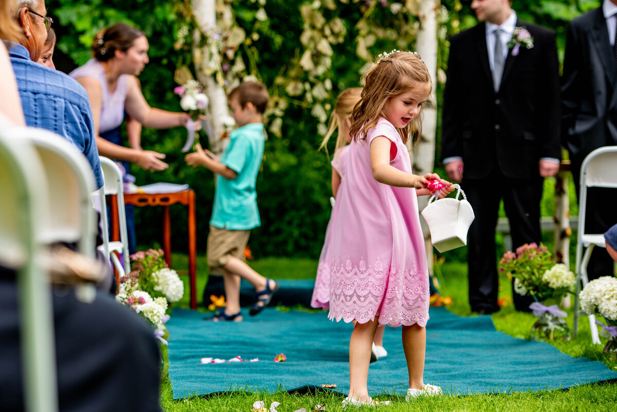 Flower girl drops petals at wedding