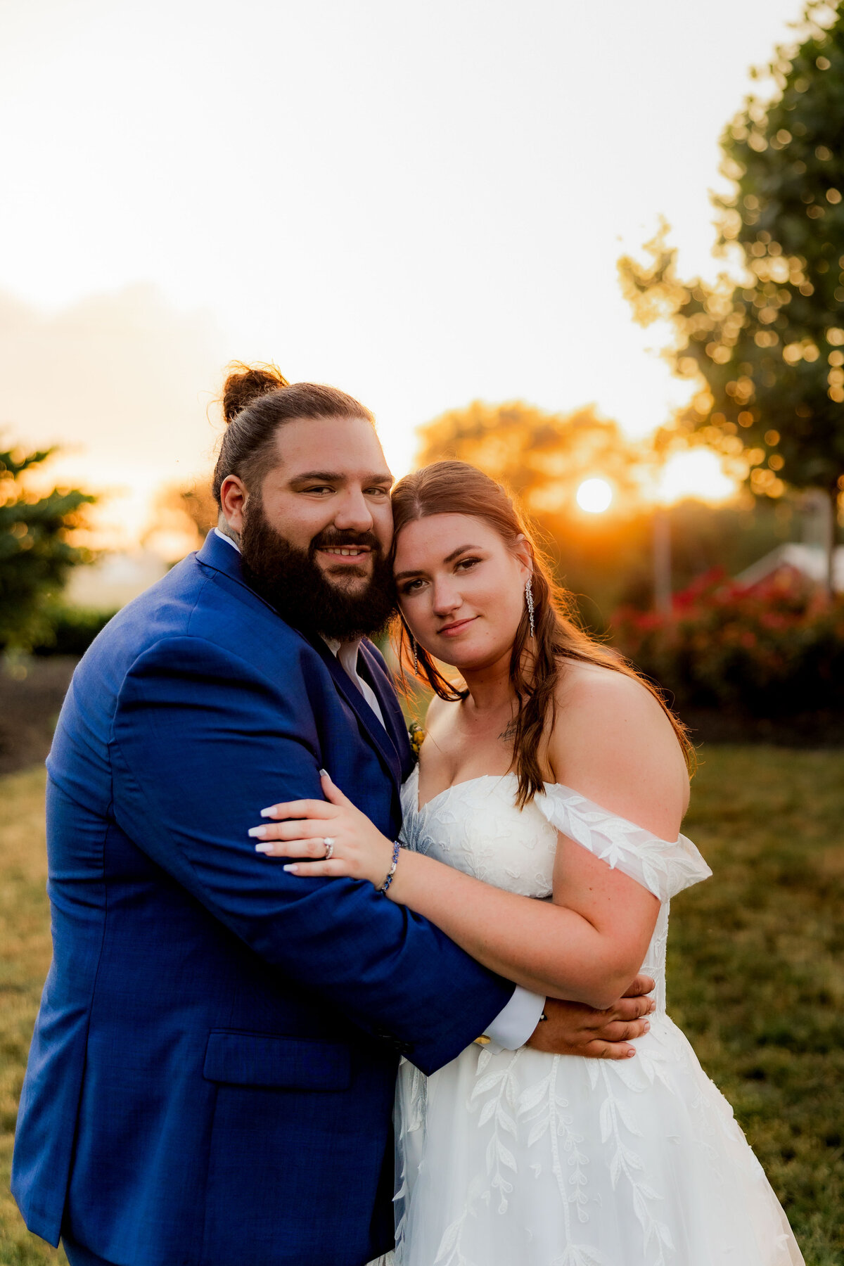 A portrait of a couple on their wedding day in sunset.