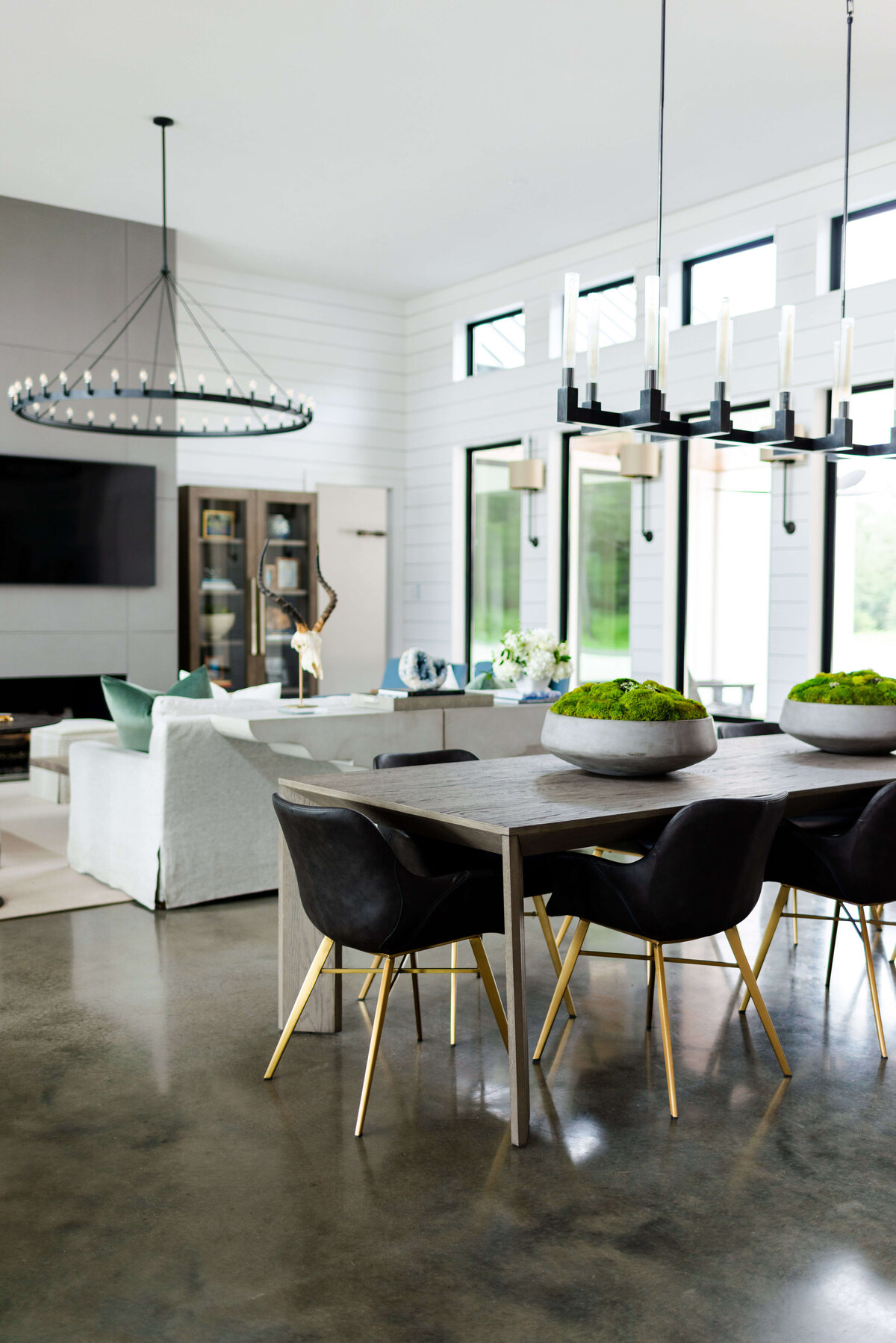 oyster creek studios building belt new build  black chairs around dining room table overlooking living room