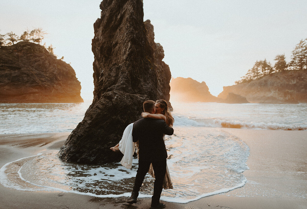 couple hugging on Oregon coast beach