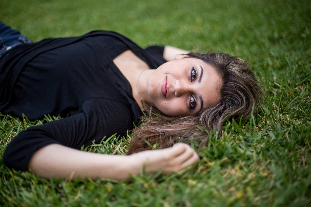 portrait photography session of a girl laying on grass by San Antonio photographer Expose The Heart