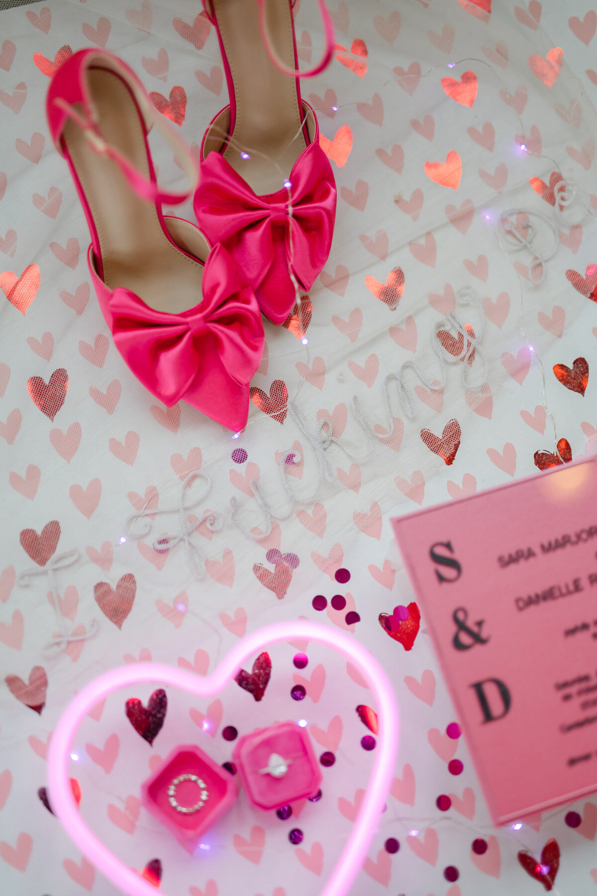 Hot pink heels and wedding rings and invitiation