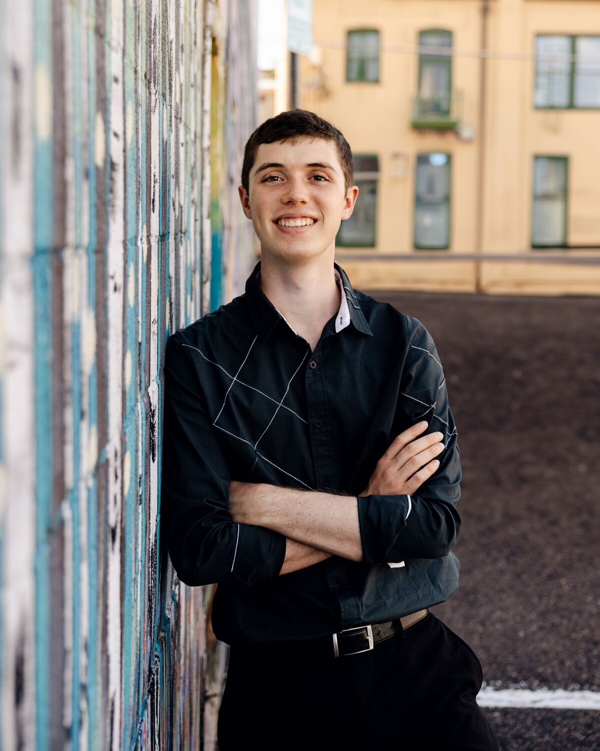 boy smiling with arms crossed