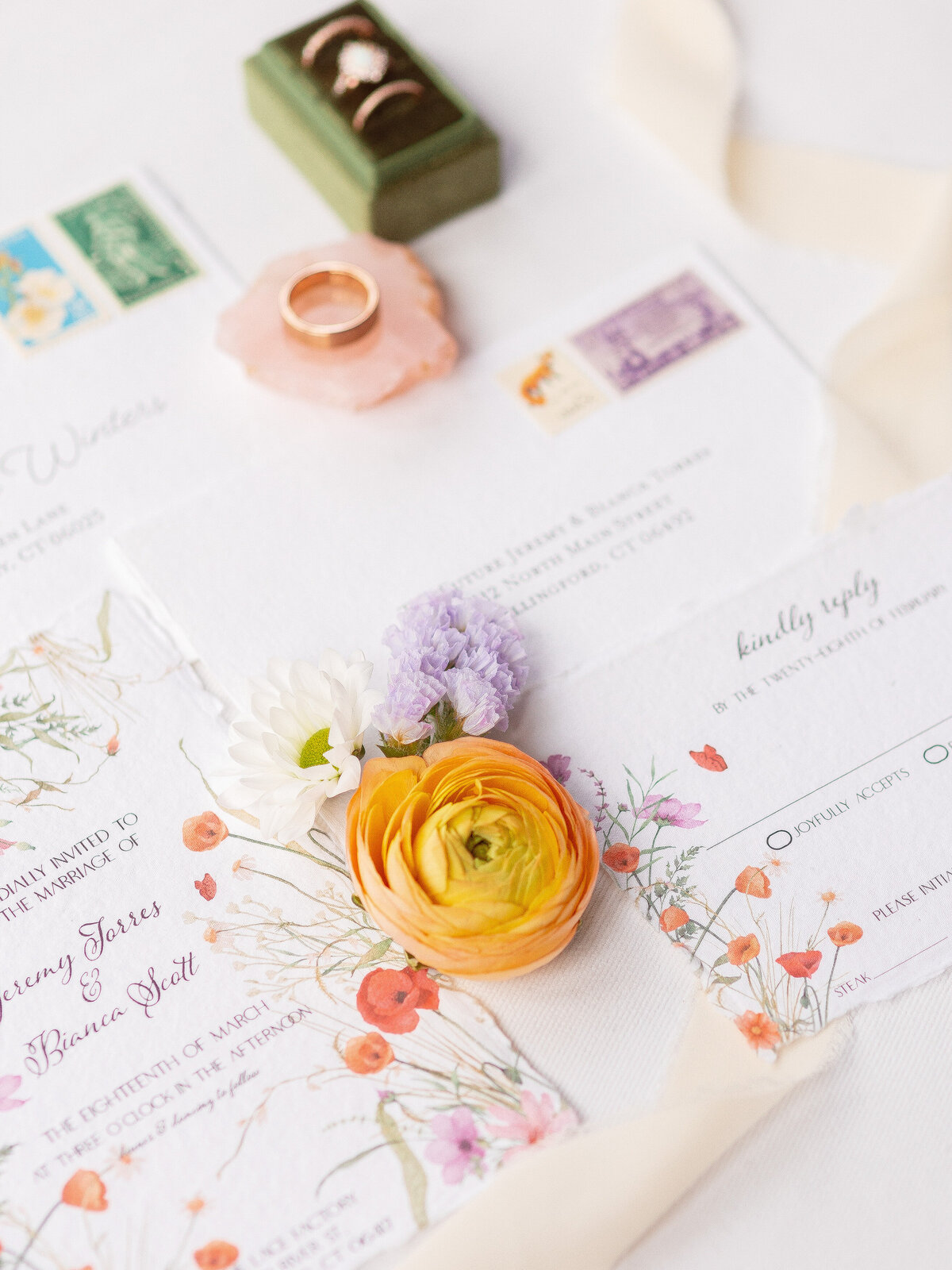 Close up of wedding invitations with florals on them