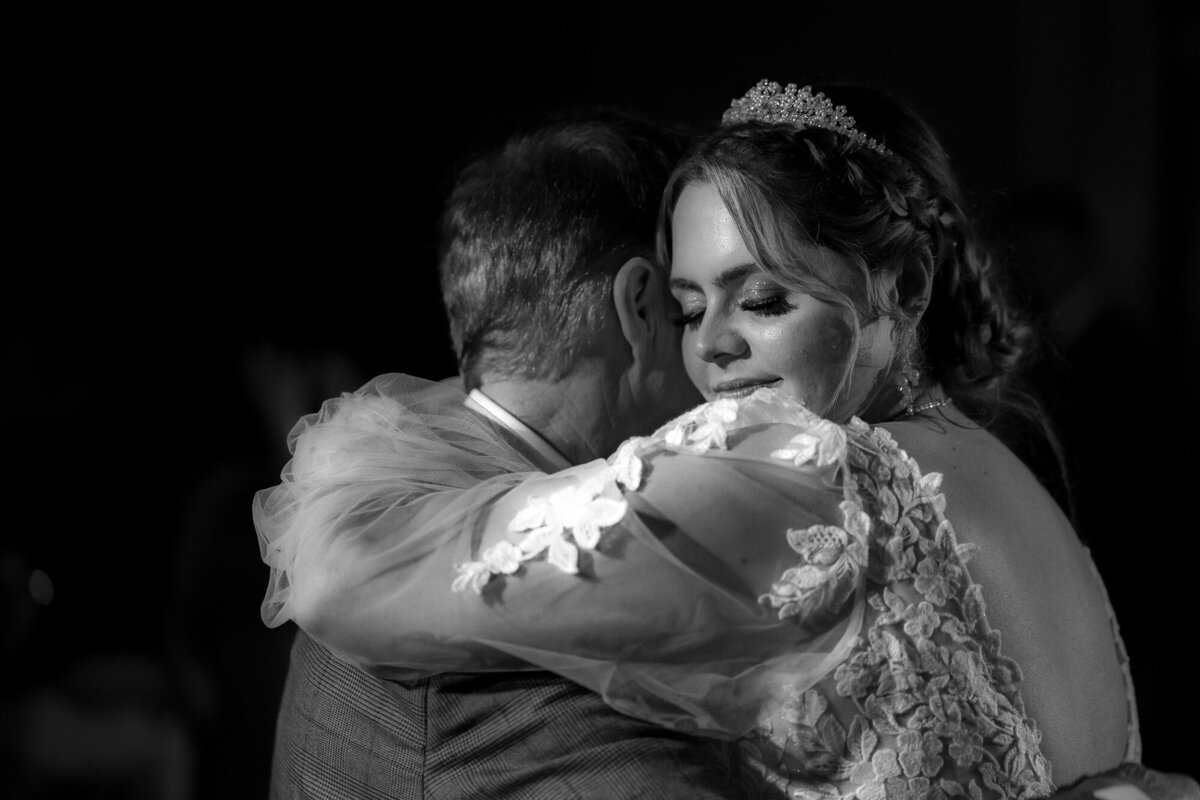 Black and white photo and bride dancing with her father at Merewood Country House Hotel taken by candid wedding photographer  Anthony Horseman