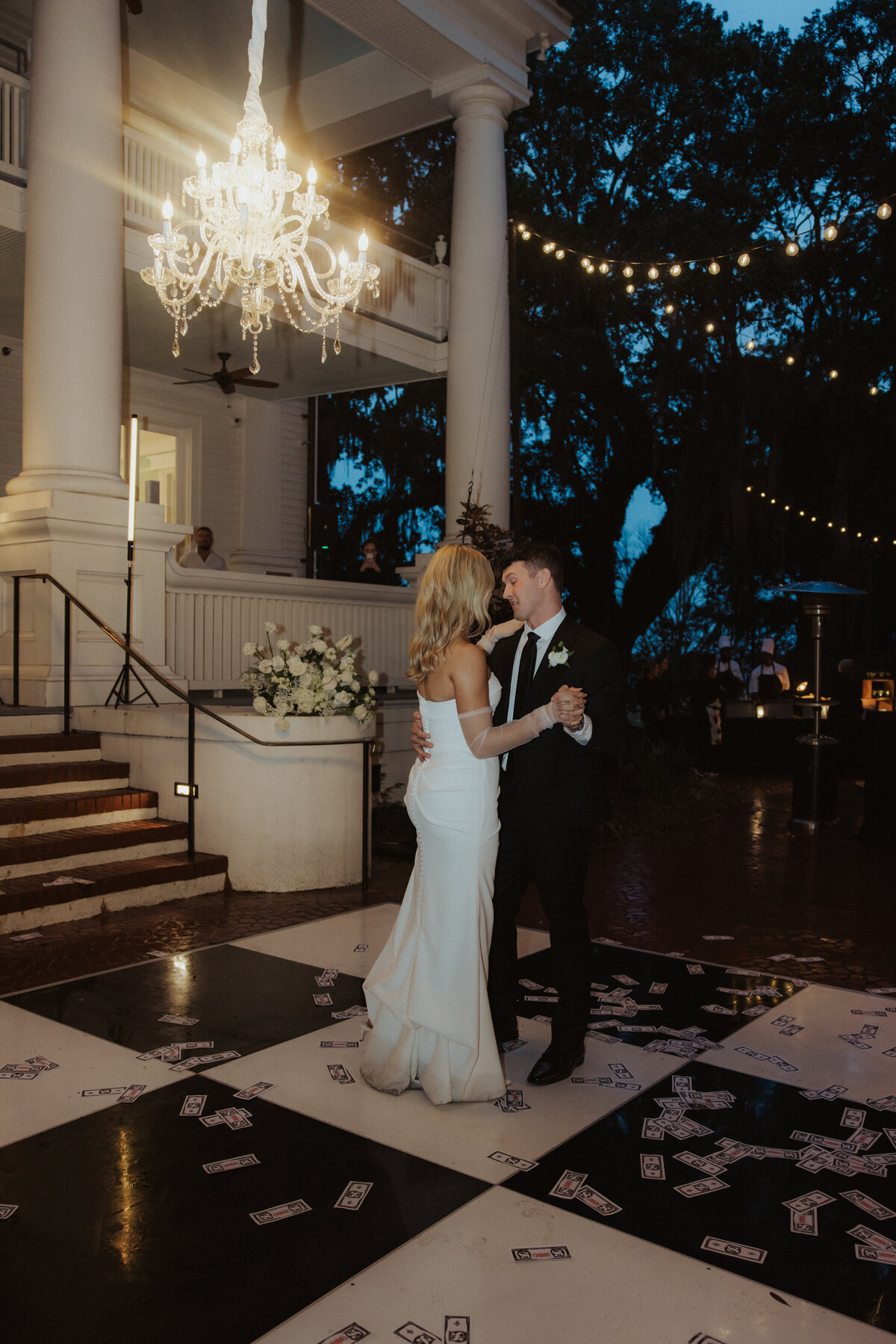 couple sharing their first dance on checkered dance floor