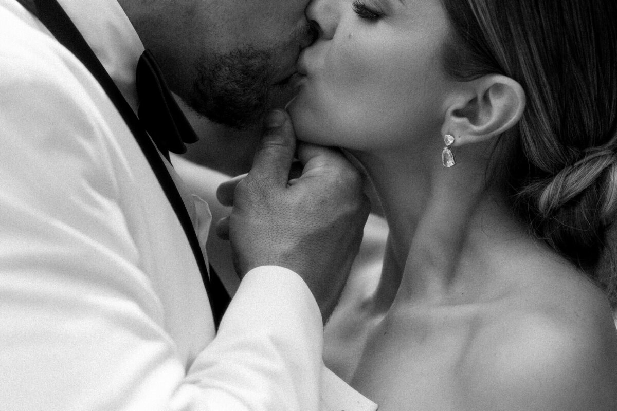 Bride and groom stealing a passionate kiss at Vizcaya Museum in Miami, FL, documented by Andrea-Marie Photography