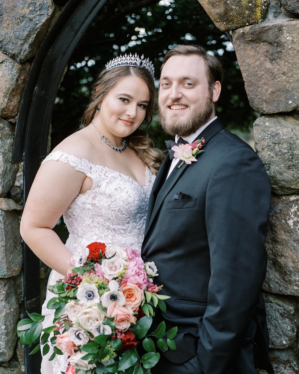 Bride and groom photo while bride holding her floral bouquet