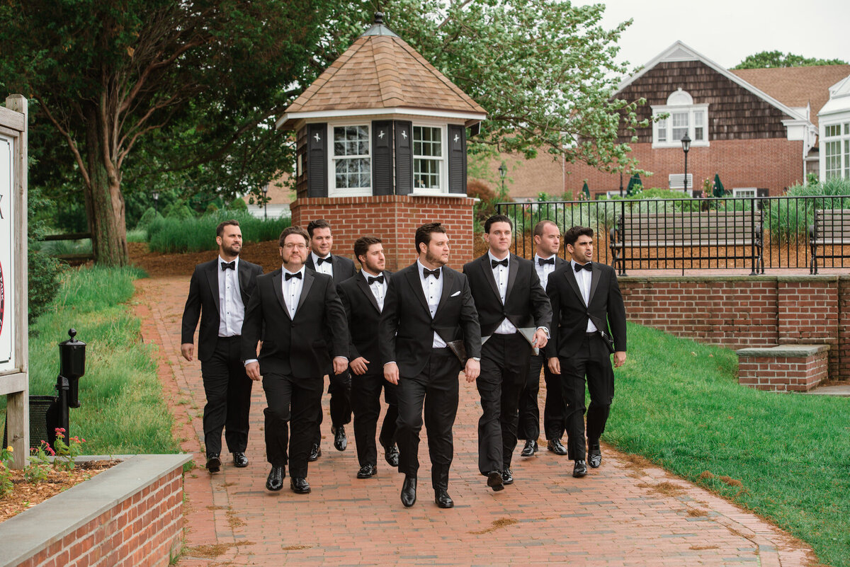 groom and his groomsmen walking the grounds of Heritage Club at Bethpage