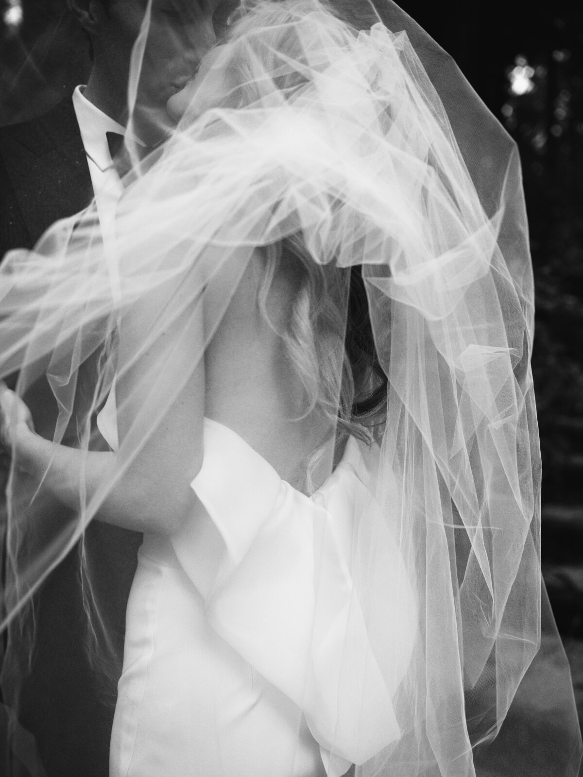 Newlyweds sharing their first dance, captured in black and white film at Nestledown in Santa Cruz, CA.