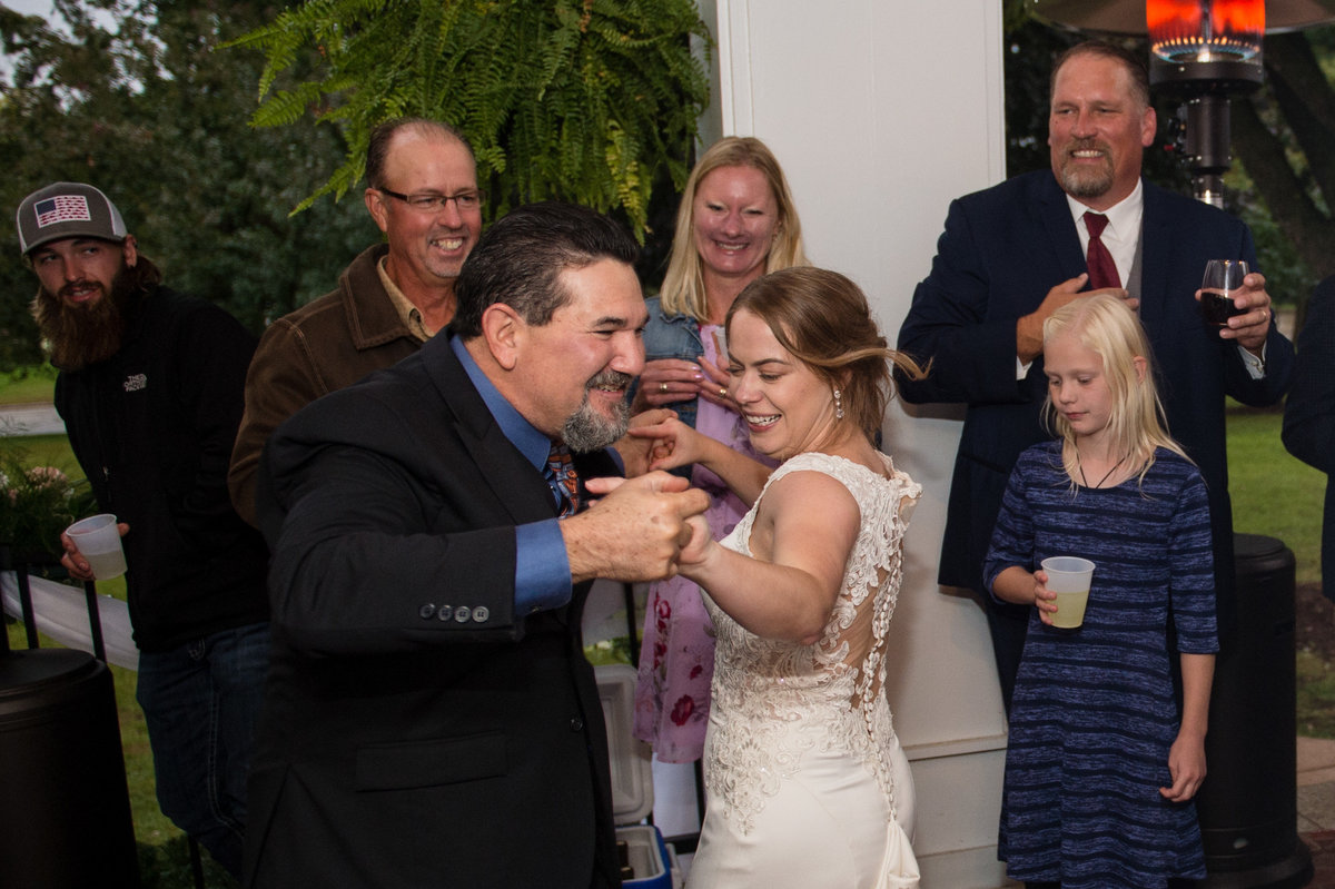 bride dancing with friend to Johnny Cash song with sideways twist