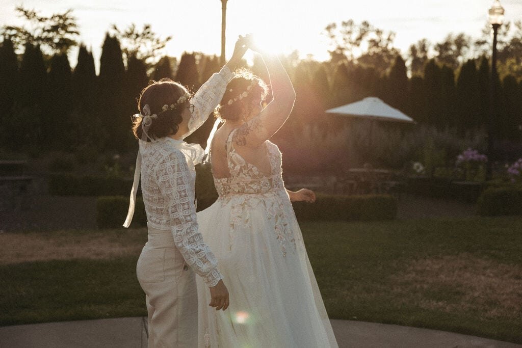 Two brides share their first dance during an intimate wedding reception.