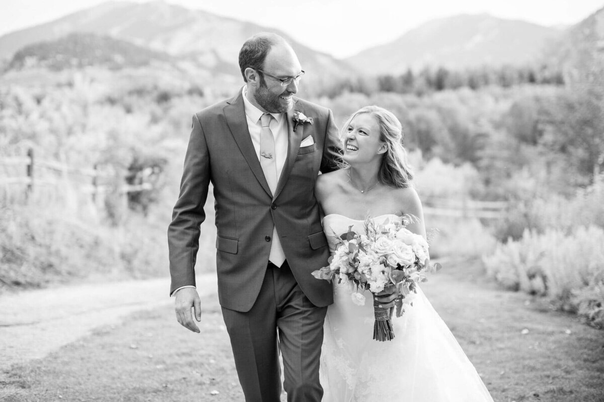 black and white image of a smiling bride and groom