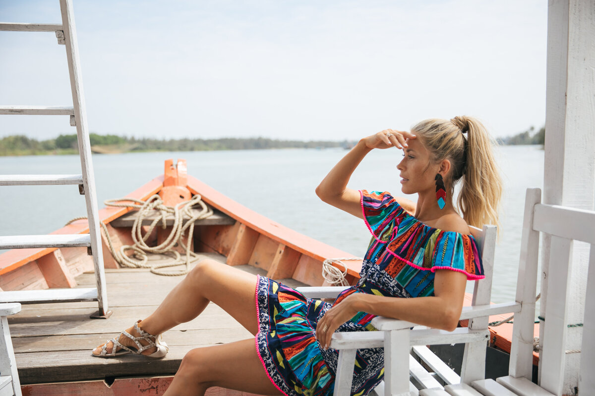 Image of woman in fun dress on a boat in Vietam