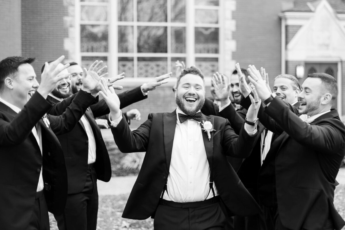 Groom walking through line of groomsmen at wedding at  The Gatsby in Shelbyville,KY