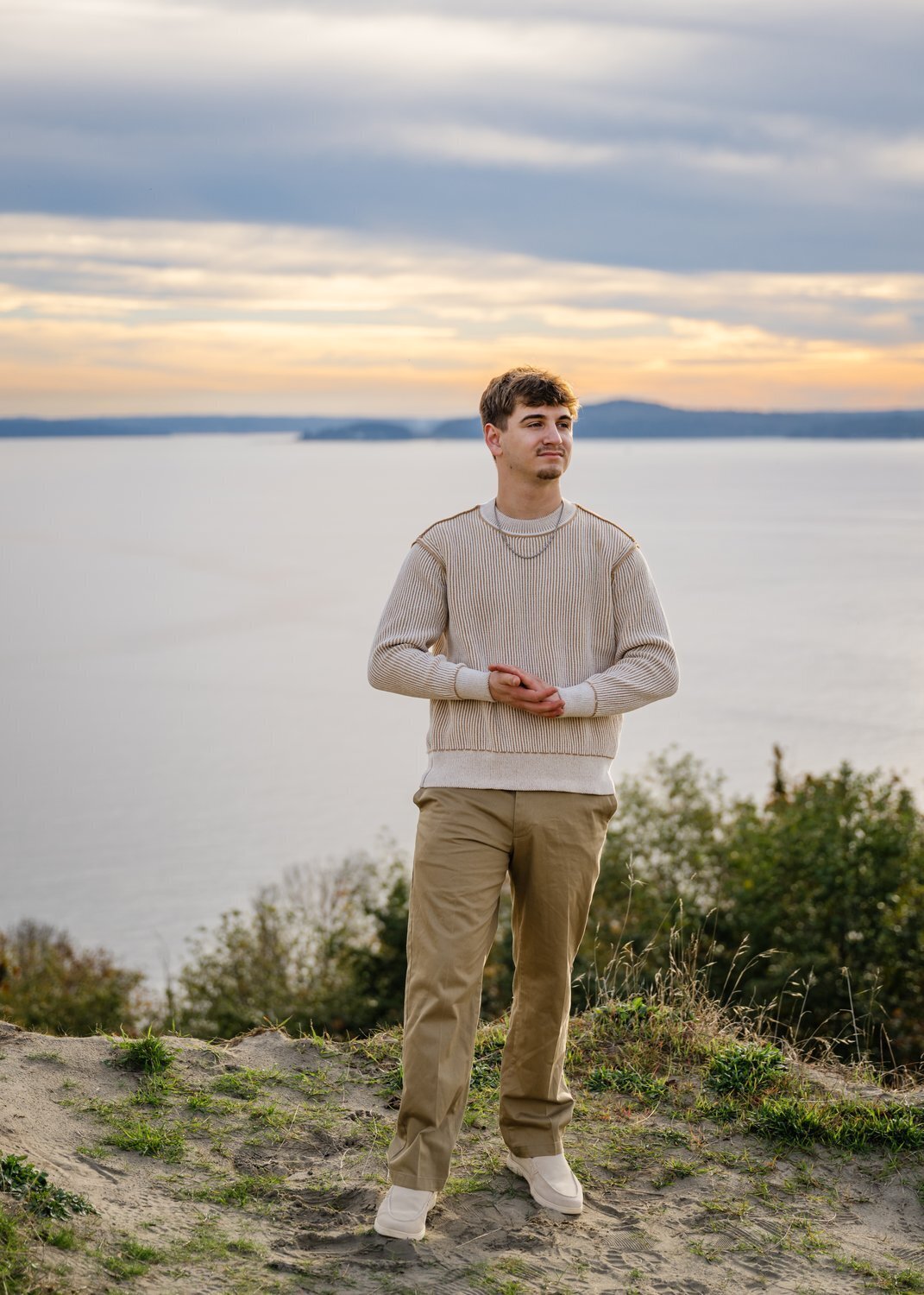high school senior on discovery park seattle bluff at sunset