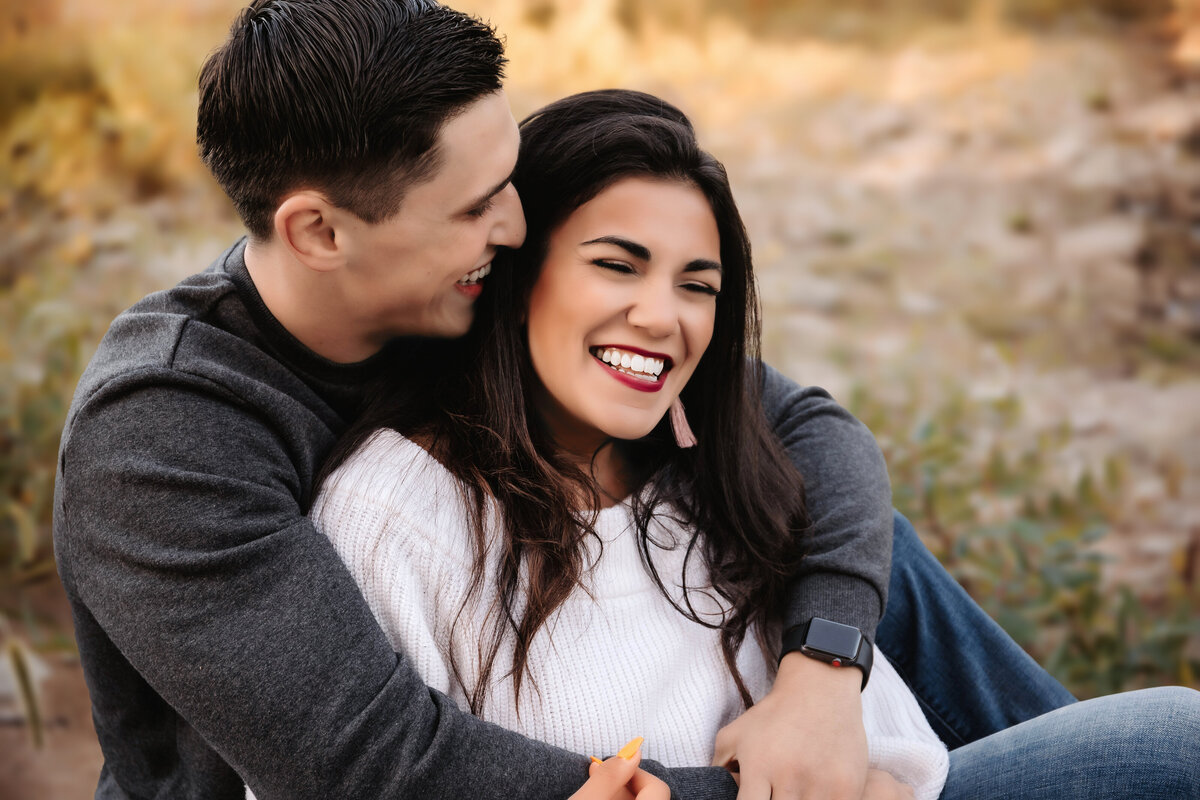 This couple shares a laugh while wrapped in each other's arms.