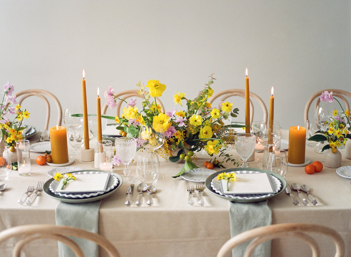 Luxury Wedding Tablescape with yellow florals from Loop Flowers,  burnt orange accents, slate blue china, linens from BBJ la Tavola and rentals from Theoni
