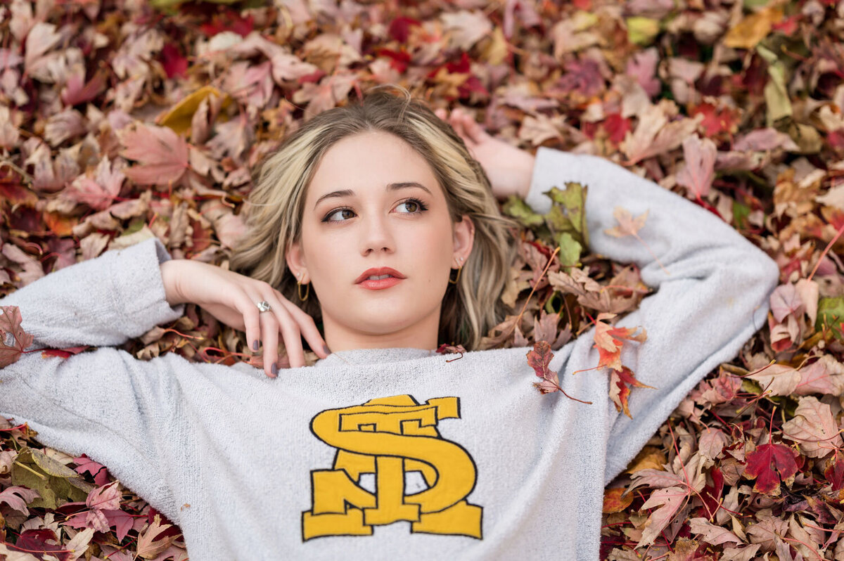 GIRL LAYING DOWN IN LEAVES