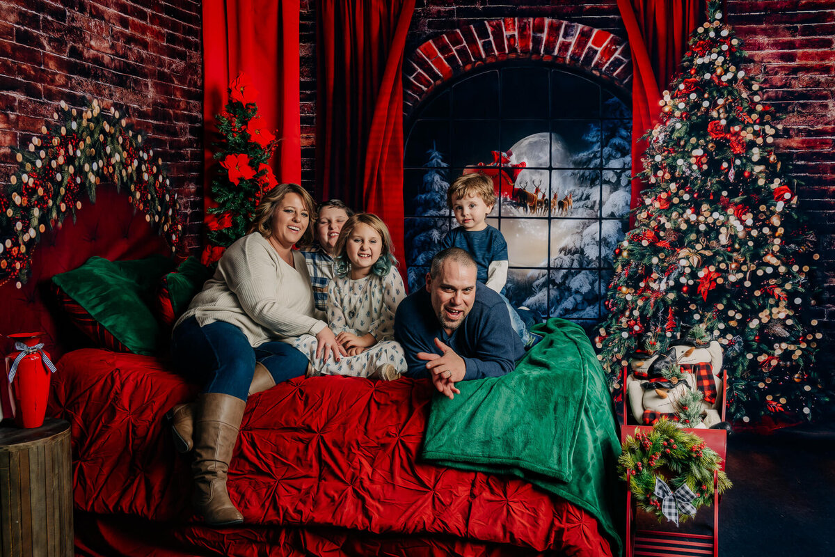 Family poses in holiday Santa session for Prescott photographer Melissa Byrne