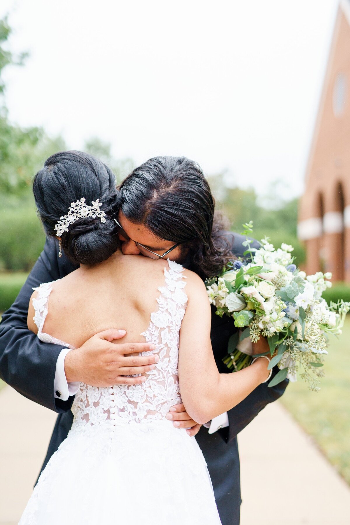 Groom buries his face in his bride's neck after an emotional first look on their wedding in Raleigh, NC.