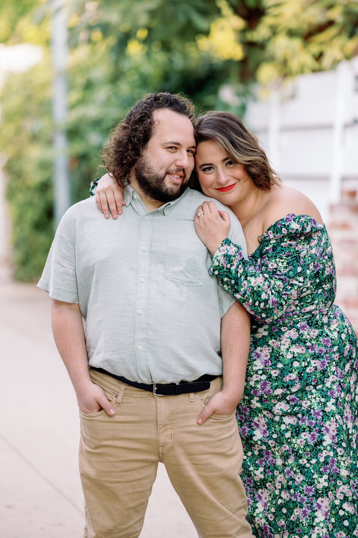 A person with her arms around her partner as they both smile