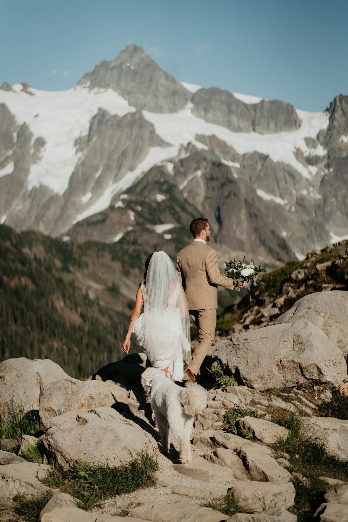 Bride and groom hiking to their elopement spot in the North Cascades