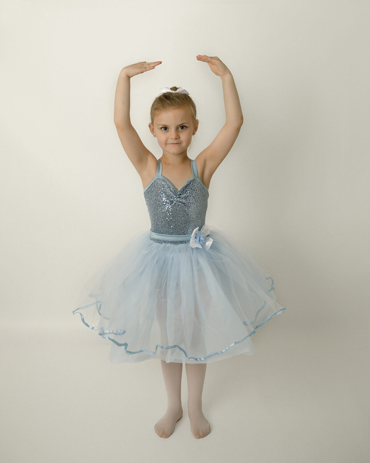 Beautiful girl dressed in a blue dance dress.