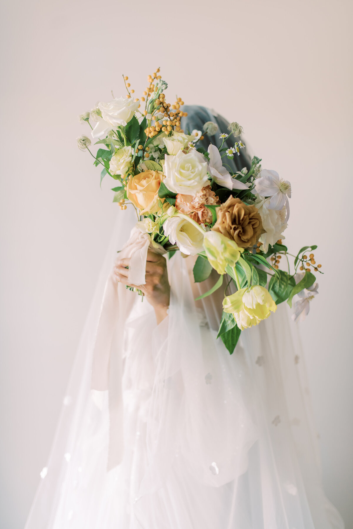 Flower bouquet and bride holding the flowers in an elegant pose in toronto.