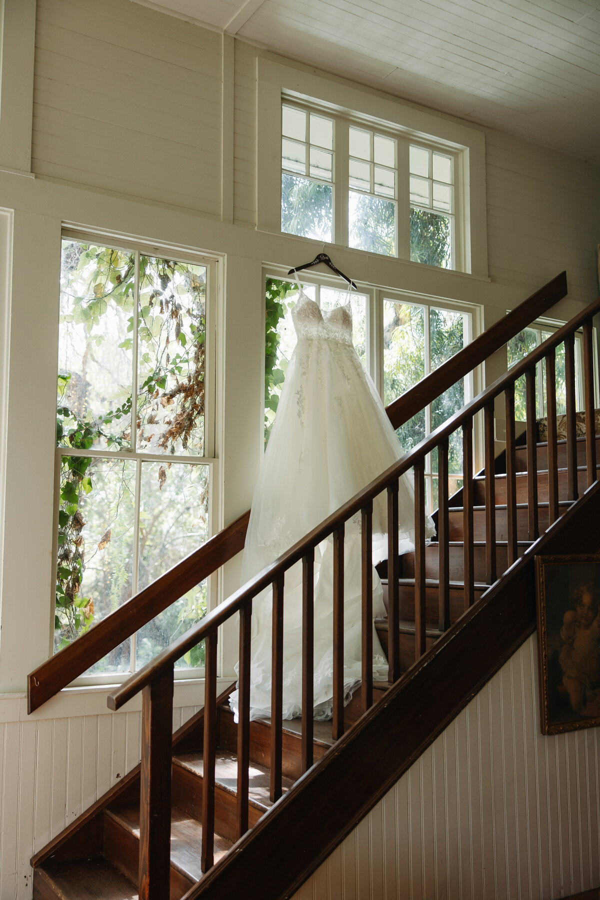 wedding dress photo, wedding dress hanging on staircase,  green gables wedding venue