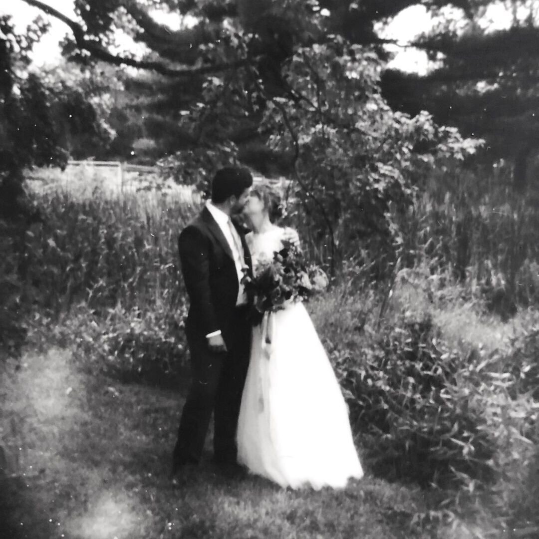 A black and white image of a bride and groom kissing tenderly in their back yard enjoying a moment of peace alone. | Pittsburgh Wedding Photographer | Anna Laero Photography