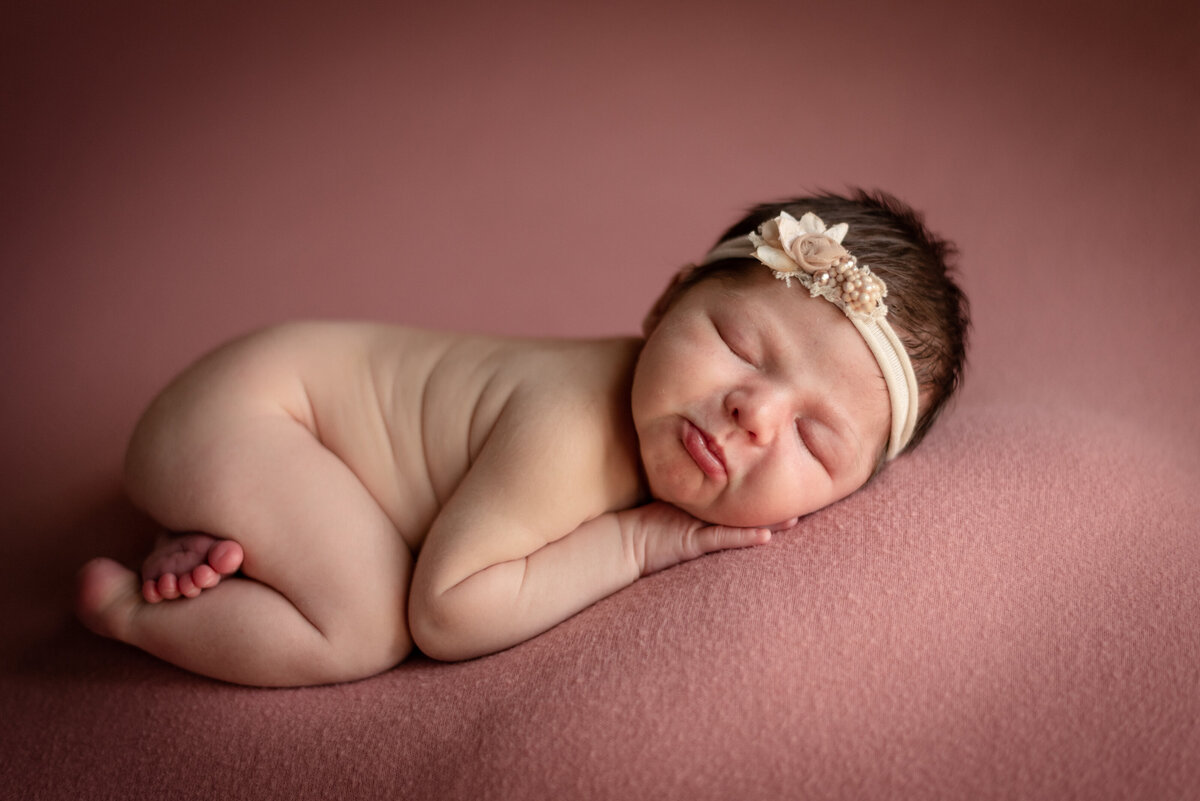 smooshy baby girl on pink with headband newborn photographer northeast fort wayne bluffton indiana
