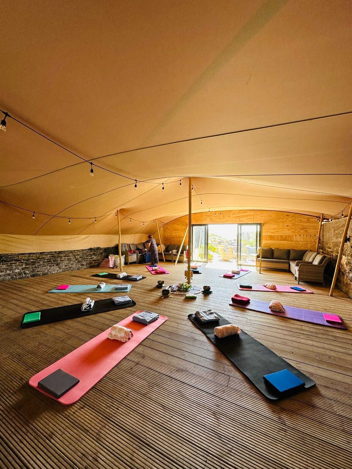 Yoga mats laid out in a marquee at the top of Polhawn Fort