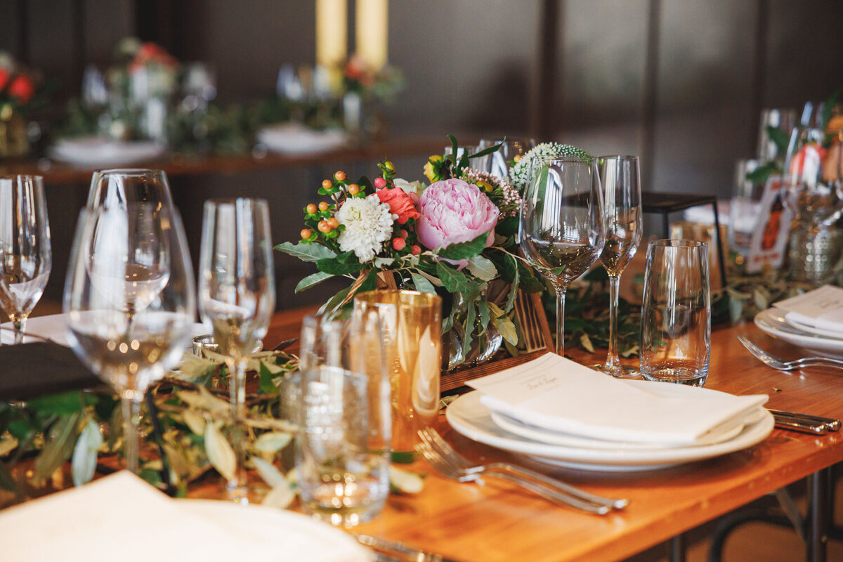 Wooden table designed with pink, white, and red florals