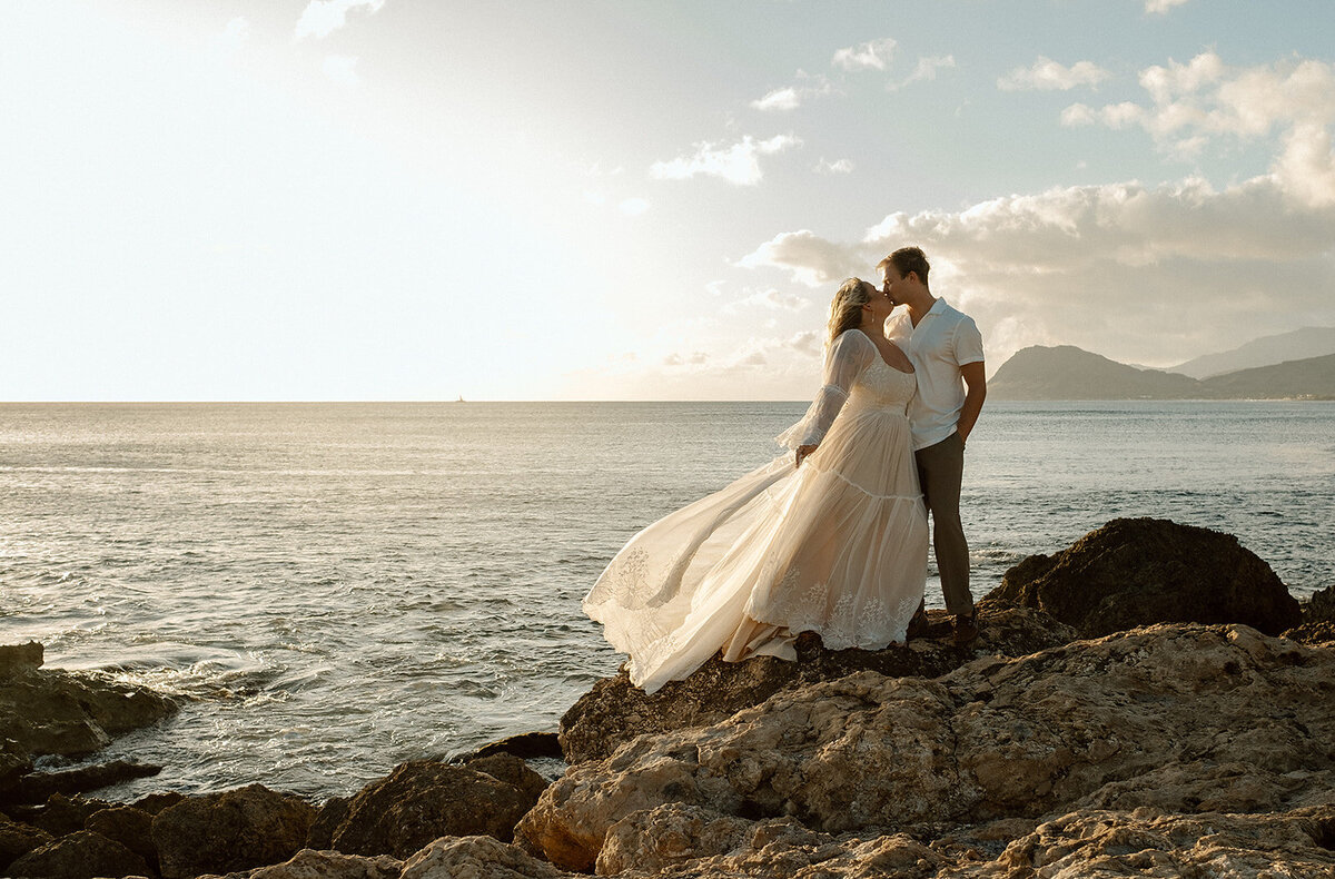 bride and groom on ocean cliff on Oahu