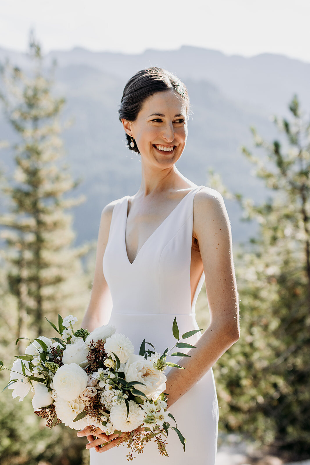 Bride smiling with custom florals for Sea to Sky Gondola Wedding Squamish - Within the Flowers
