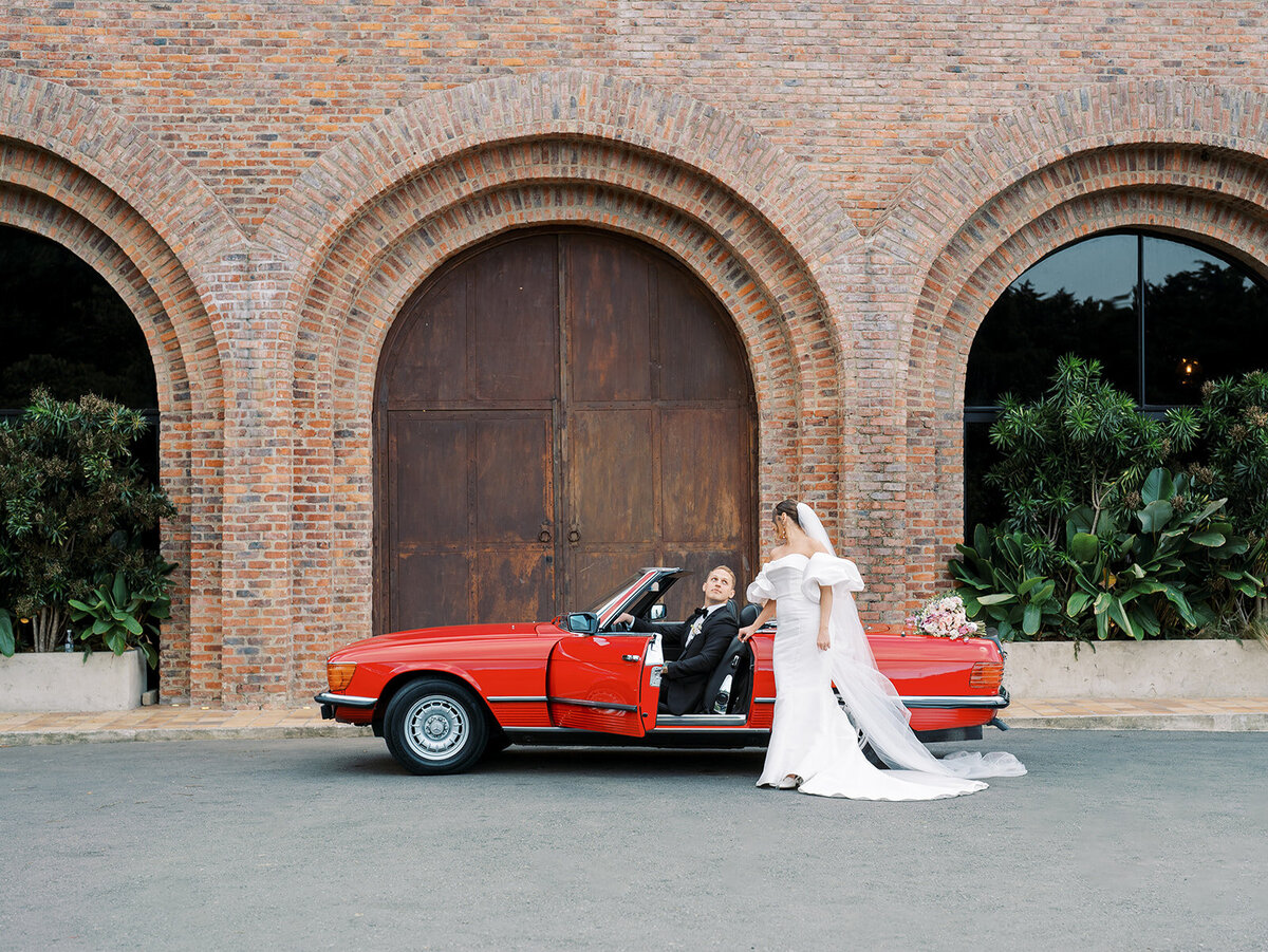bride and groom walk around their venue and look at each other in a blurry modern image