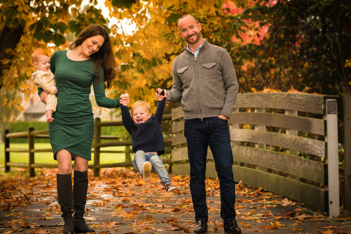 parents-swinging-son-fall-photoshoot