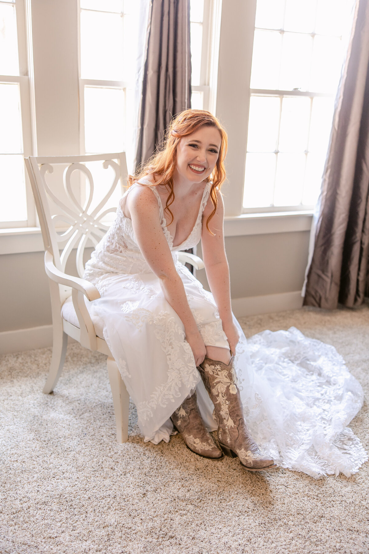 bride puts on boot before wedding ceremony in Boerne Texas