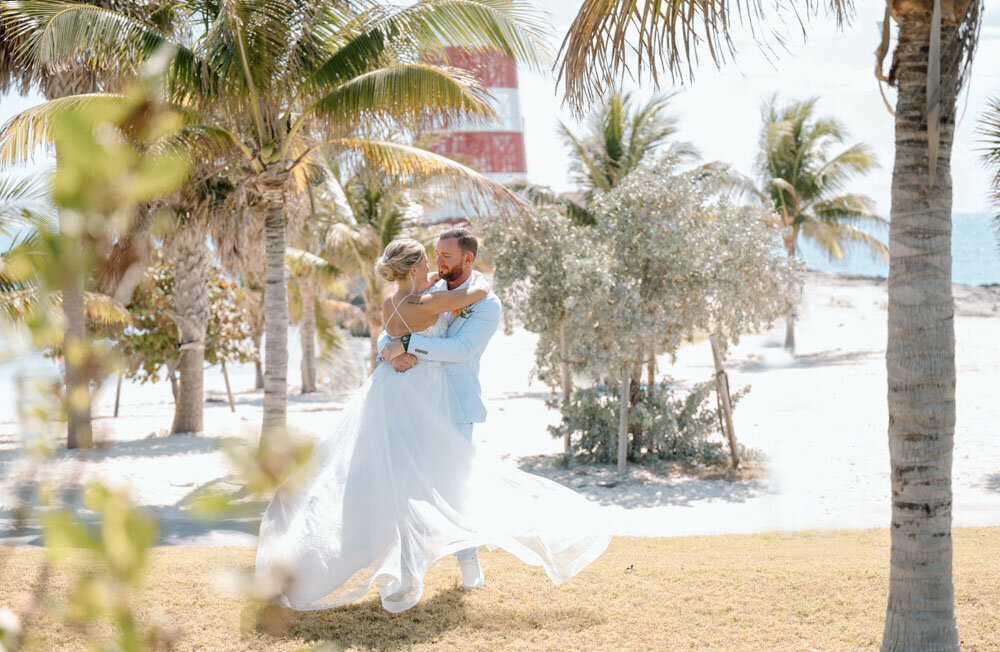a couple dances on the beach in the Bahamas
